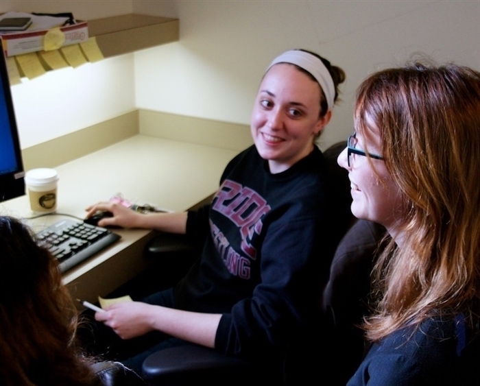 student and professor chatting at computer