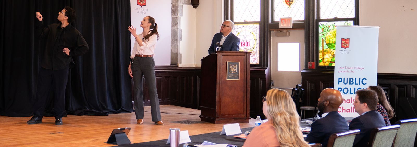 students presenting at the Public Policy Analysis Challenge in front of a panel of judges
