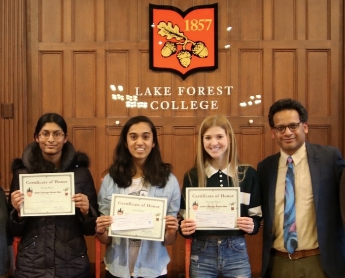 three Brain Bee winners holding certificates and professor