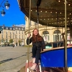 Jennifer Valdes Del Valle riding a carousel